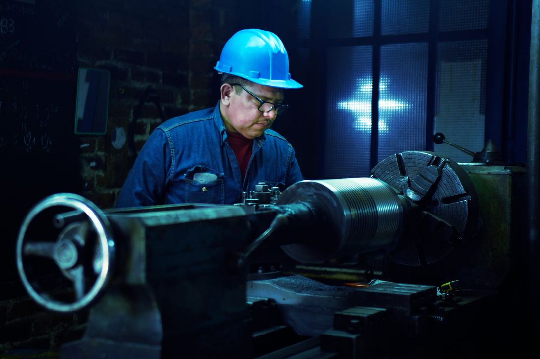 Engineer operating a lathe in the Fortalum workshop